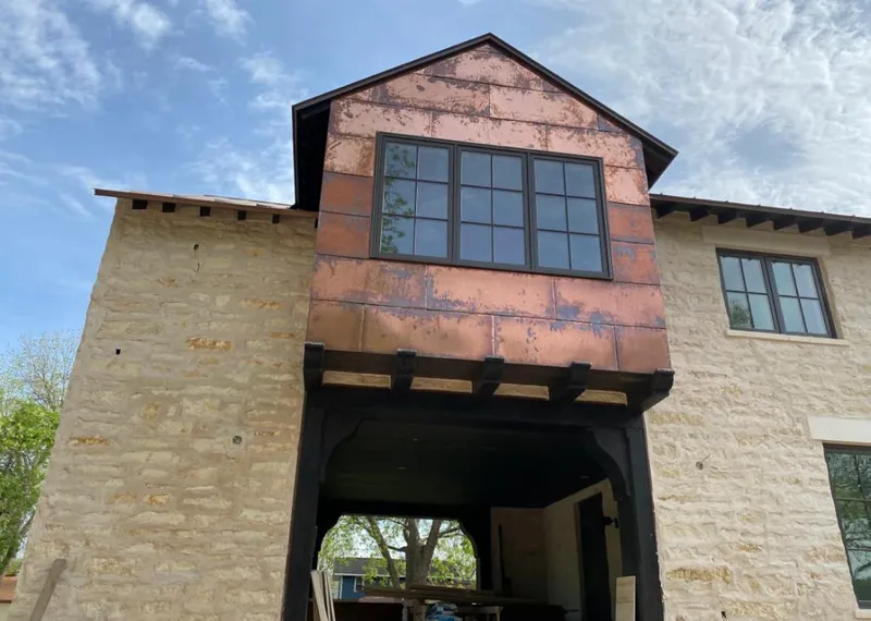 Copper metal panel facade on a stone building for Skylight Installation in Hesperia